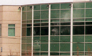 Eric Harris and Dylan Klebold shoot at police from the windows of Columbine's library.