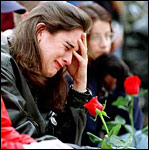 Teacher cries at a memorial gathering