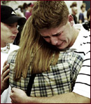 Matt Charmichael, a Columbine student, hugs his friend