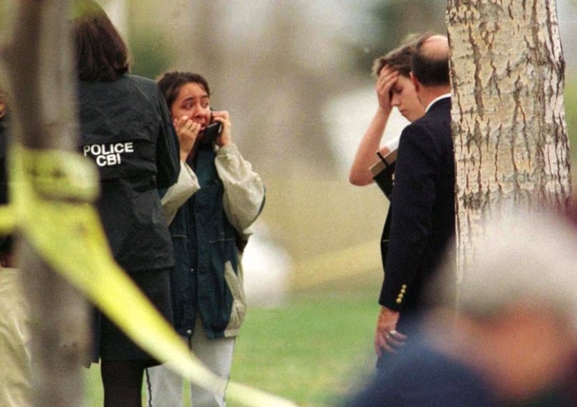 Police talk to a survivor of the Columbine shootings