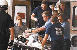 Paramedics load one of the more critically injured Columbine victims into an ambulance